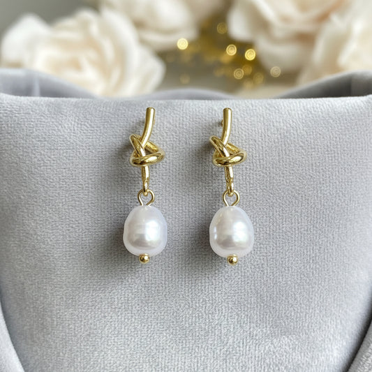 Pearl Knot Drop Earrings on grey velvet