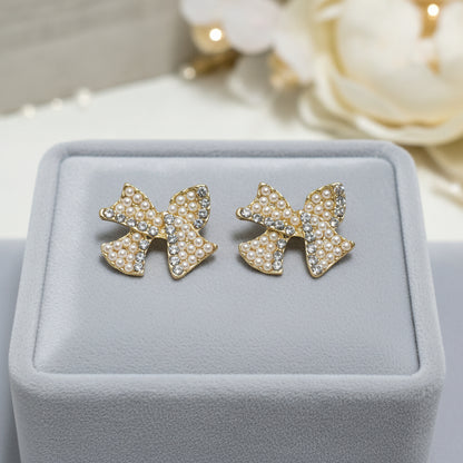 Pearl & Pavé Bow Earrings on grey velvet