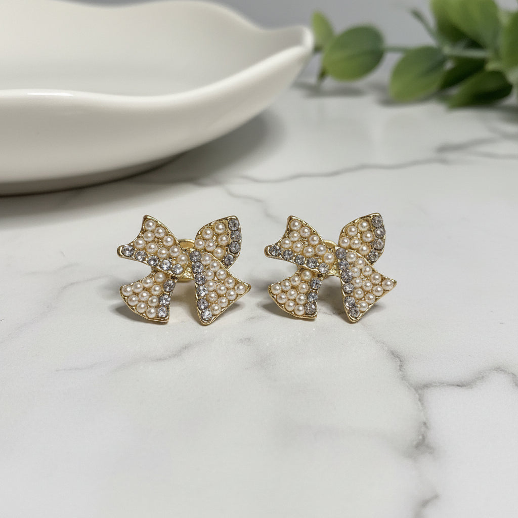 Pearl & Pavé Bow Earrings on marble