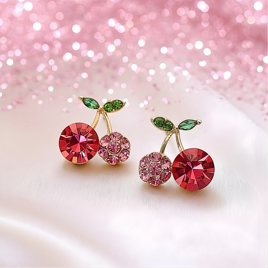 Pink Zircon Cherry Earrings with red and pink gemstones on a glittery pink background
