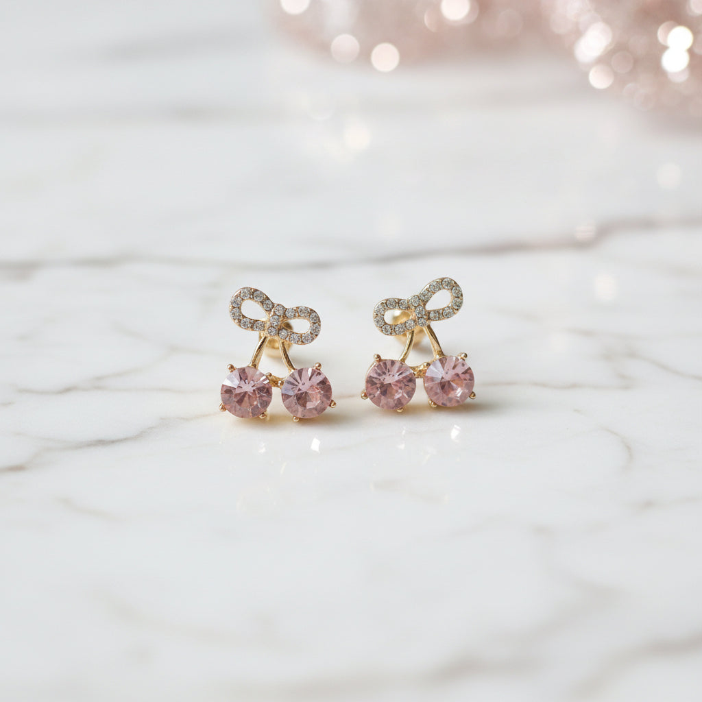 Pink Cherry Pavé Bow Earrings on marble