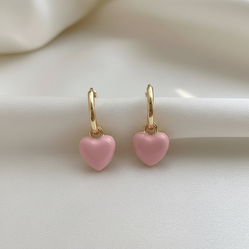 Pink Heart Huggie Earrings a white background