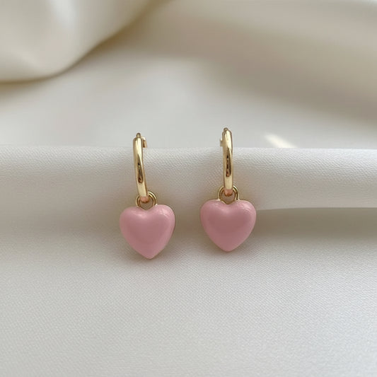 Pink Heart Huggie Earrings a white background