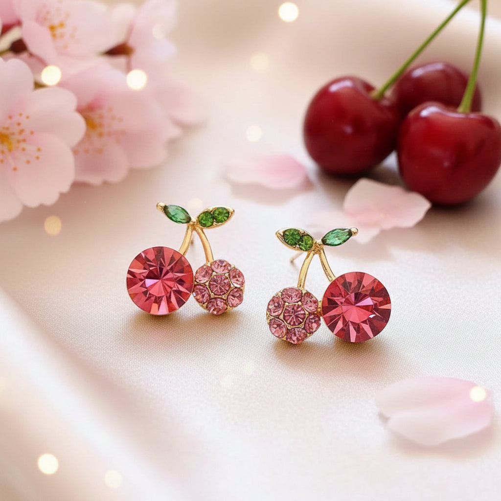 Pink Zircon Cherry earrings with red and green gemstones on a beige background