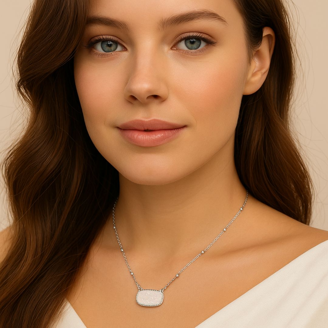 Woman wearing a White Opal Druzy Glow Pendant Silver Necklacewith a beige background