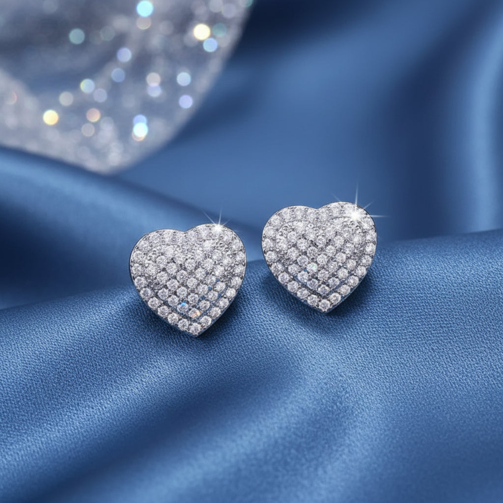 Radiant Heart Pavé Earrings on a blue fabric background