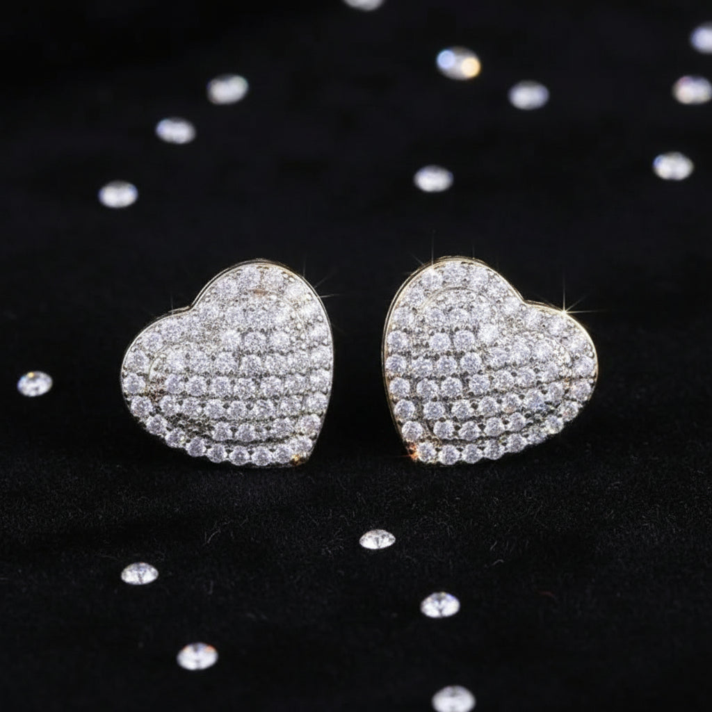 Radiant Heart Pavé Earrings on a textured black surface