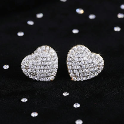 Radiant Heart Pavé Earrings on a textured black surface
