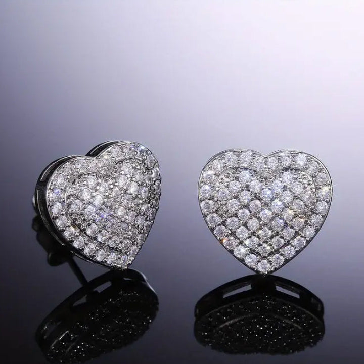 Radiant Heart Pavé Earrings with diamond pavé on a reflective surface