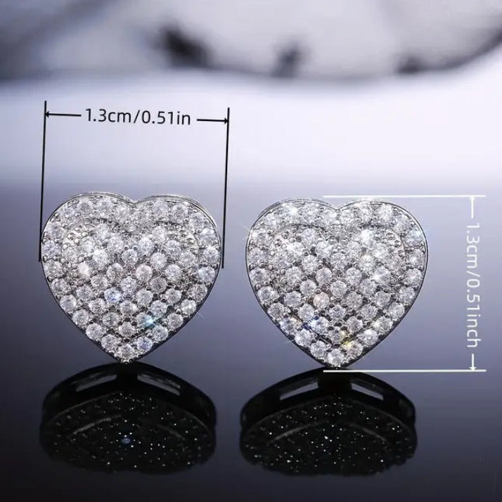 Radiant Heart Pavé Earrings with clear stones on a reflective surface, showing measurements.