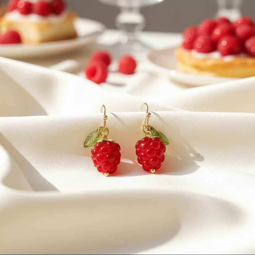 Raspberry Drop Earrings on a table