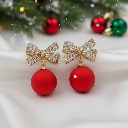 Red Ornament Pavé Bow Earrings on holiday background