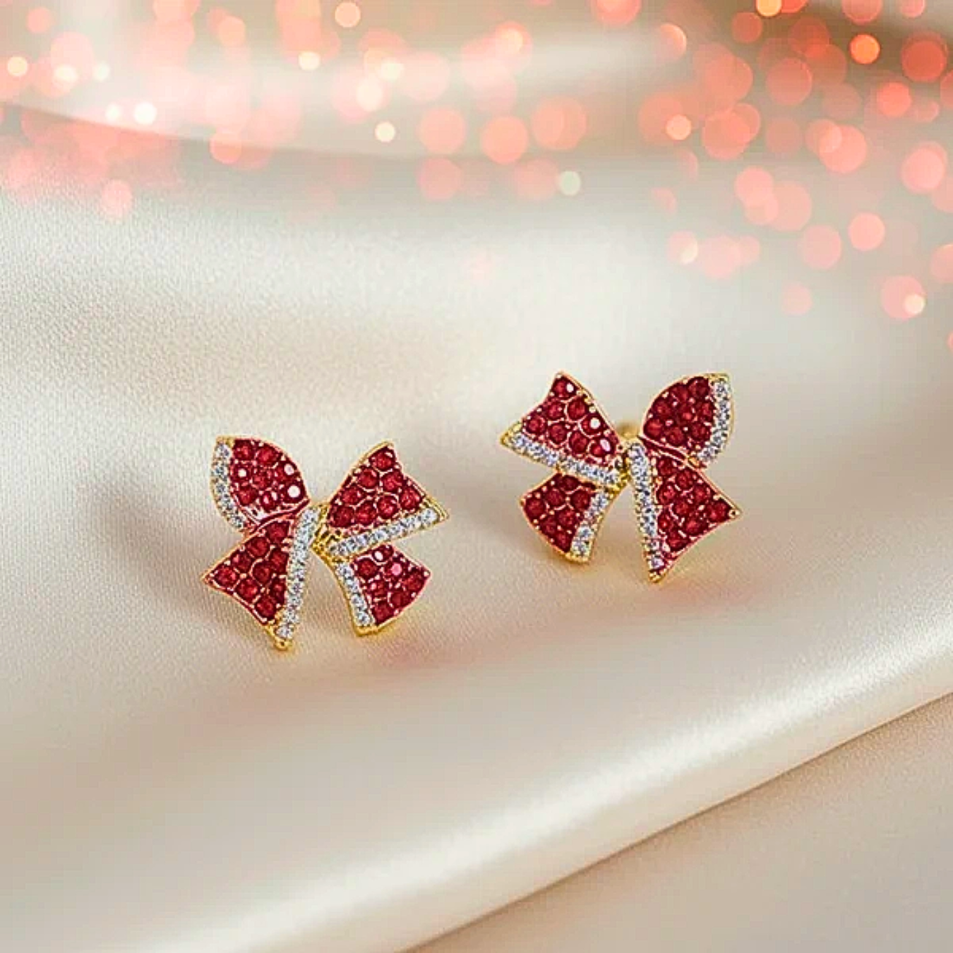 Red Rhinestone Bow Earrings on white satin fabrick
