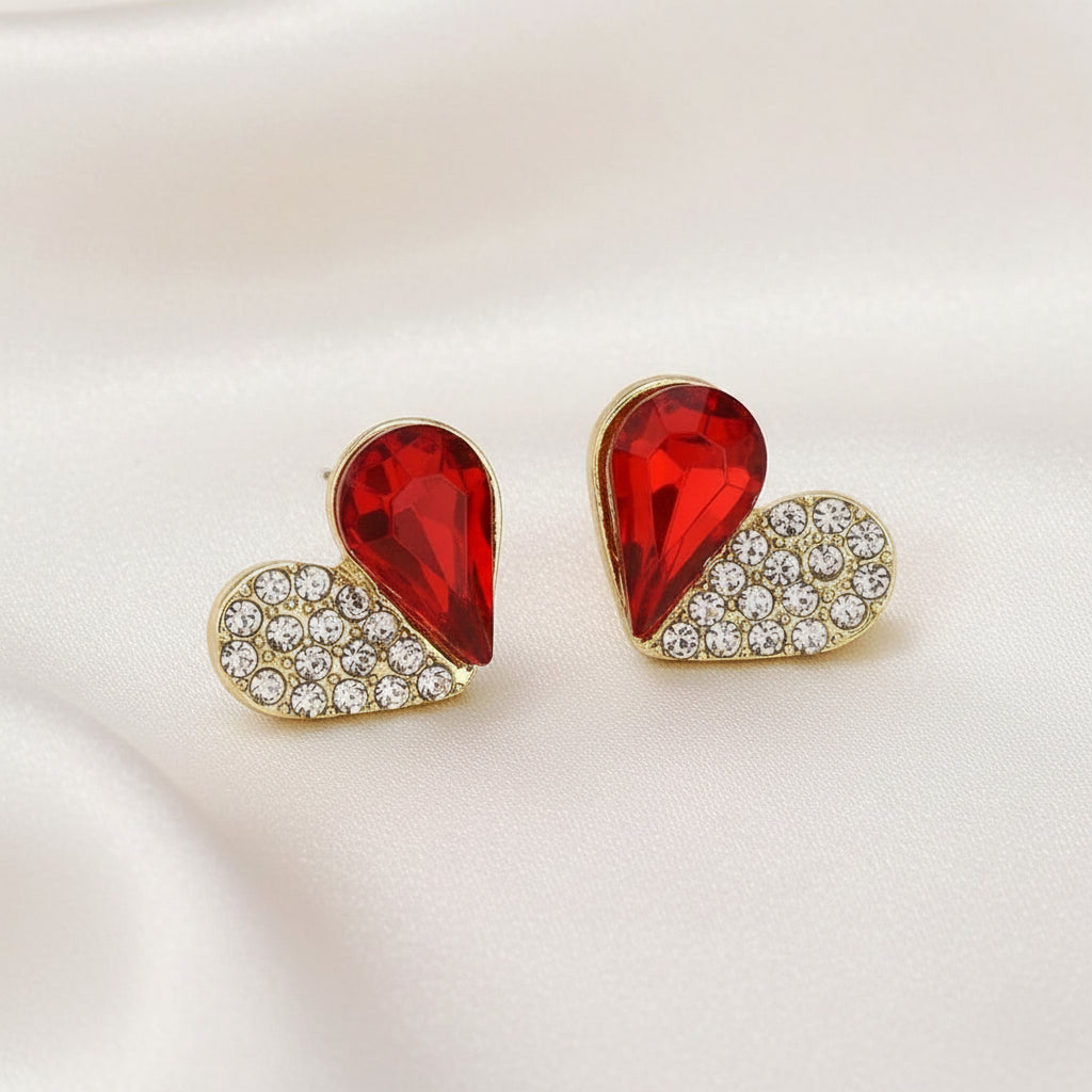 Ruby Crystal Heart Pavé Earrings with red gemstones and gold accents on a white background