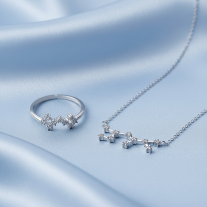 Silver Sagittarius Zodiac Necklace & Ring Bundle on a soft blue fabric background