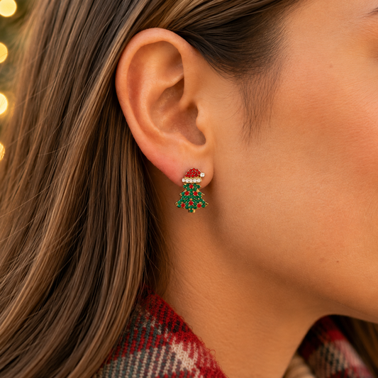 A close-up of a woman's ear wearing a Santa Hat Christmas Tree Pavé Earring