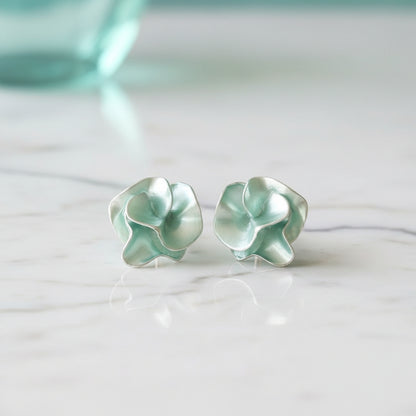 Seafoam Pearlescent Petal Earrings on marble