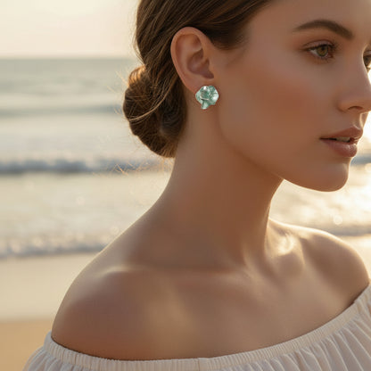 Woman wearing Seafoam Pearlescent Petal Earrings on a beach