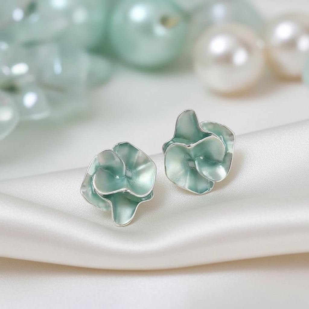 Seafoam Pearlescent Petal Earrings on a soft fabric background