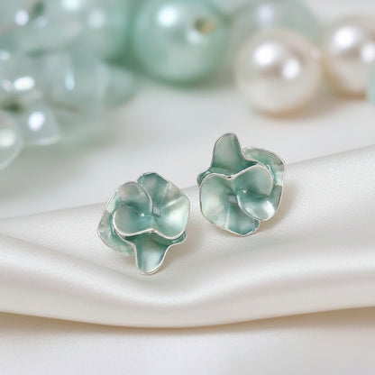 Seafoam Pearlescent Petal Earrings on a soft fabric background