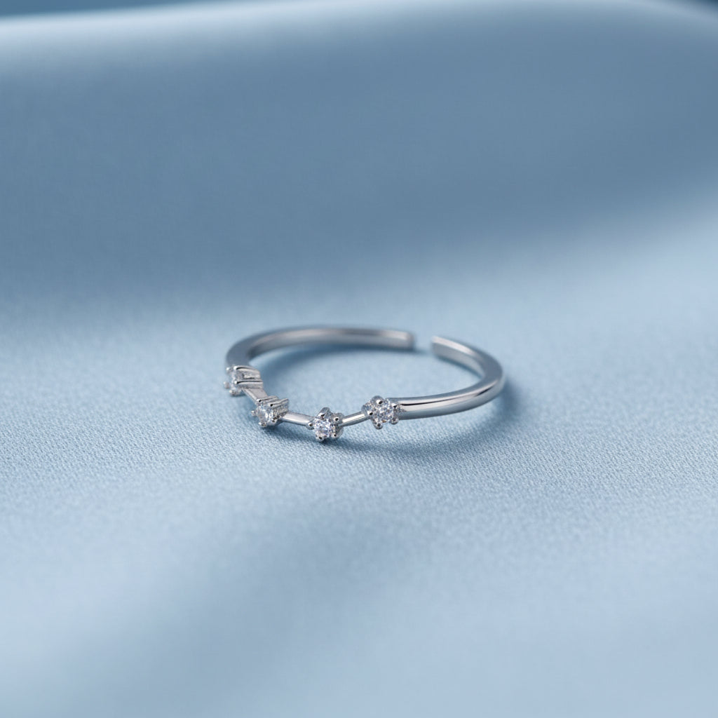 Silver Aquarius Zodiac Ring on a light blue background