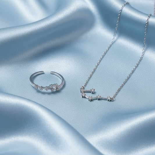 Silver Cancer Zodiac Necklace & Ring Bundle on a blue satin fabric background