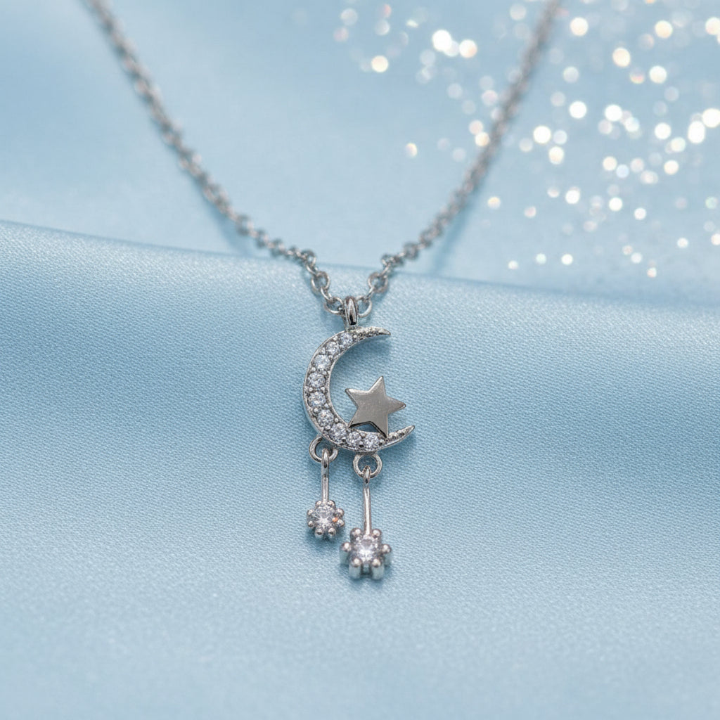 Silver Celestial Moon & Star Dangle Necklace on a light gray background