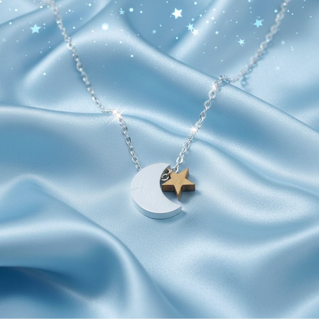 Silver & Gold Crescent Moon Star Necklace on a blue satin background