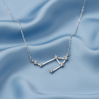 Silver Libra Zodiac Necklace on a light blue background