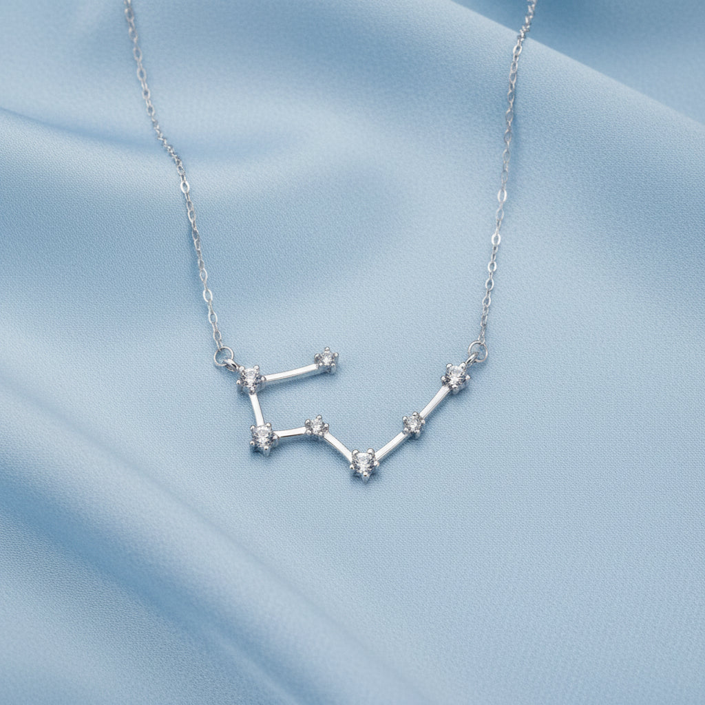 Silver Taurus zodiac necklace on a white background