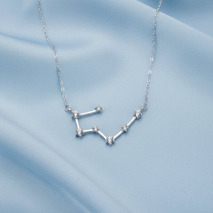 Silver Taurus zodiac necklace on a white background