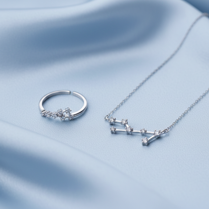 Silver Virgo Zodiac Necklace & Ring Bundle on a light blue background