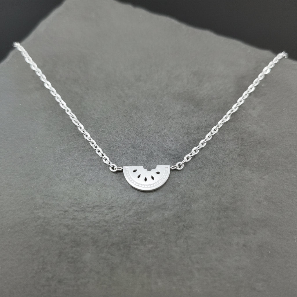 Silver Watermelon Slice Necklace on a gray background