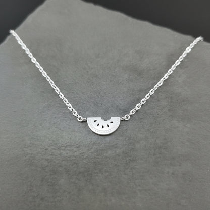 Silver Watermelon Slice Necklace on a gray background