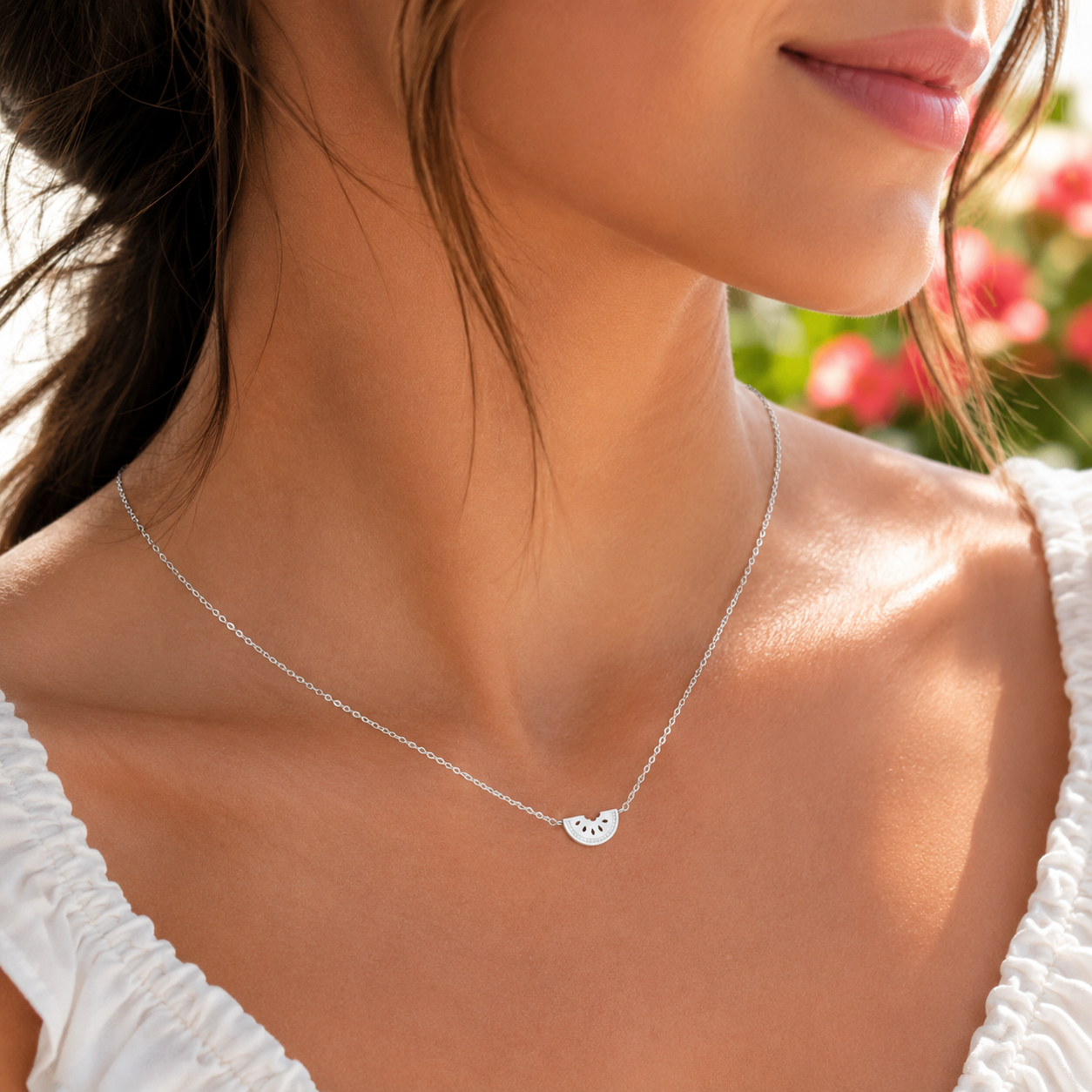 Close-up of a woman wearing a Silver Watermelon Slice Necklace