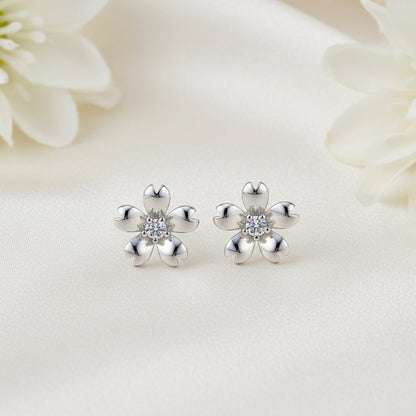 Silver Zirconia Flower Earrings with clear stones on a white floral background