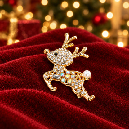 A gold-toned Sparkling Pavé Reindeer Pin on red velvet