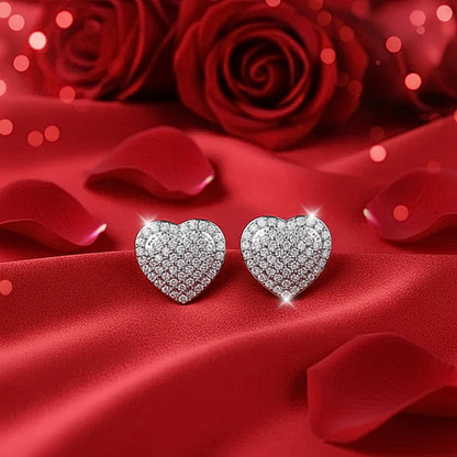 Radiant Heart Pavé Earrings on red fabric with red roses in the background