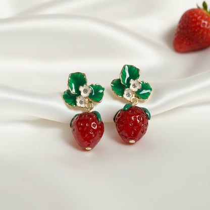 Strawberry Blossom Drop Earrings on a white satin background.