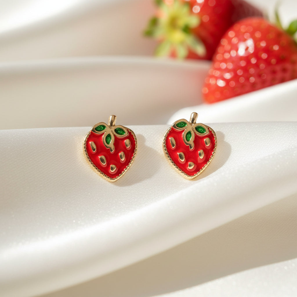 Strawberry Patch Earrings with green gemstones on a white satin background