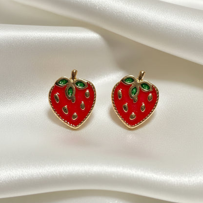 Strawberry Patch Earrings with green gemstones on a white satin background