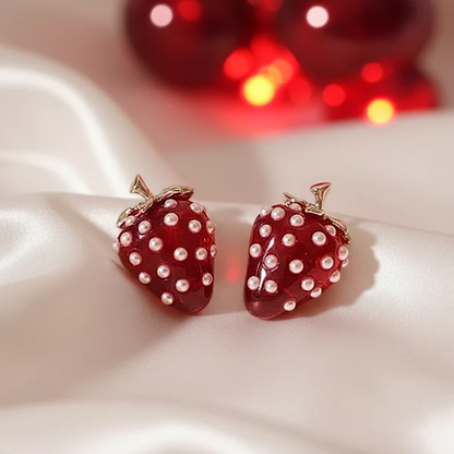 Strawberry Pearl Earrings with pearl details on a white fabric background