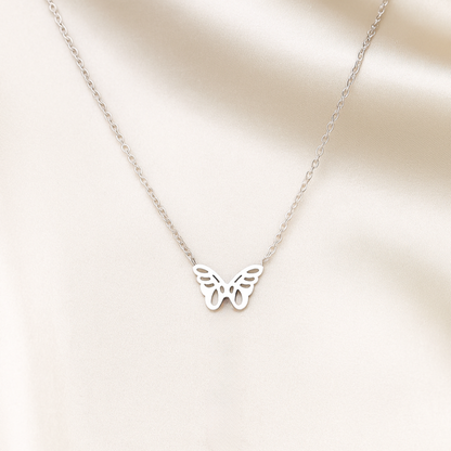 Silver Origami Butterfly Necklace on a beige background