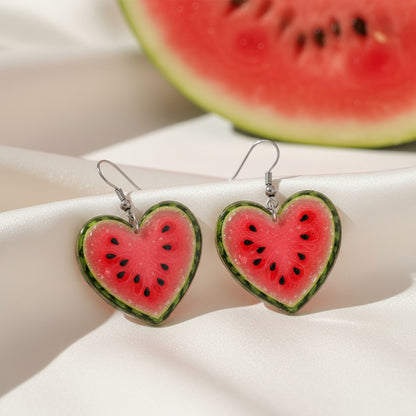Watermelon Heart Earrings on table with watermelon