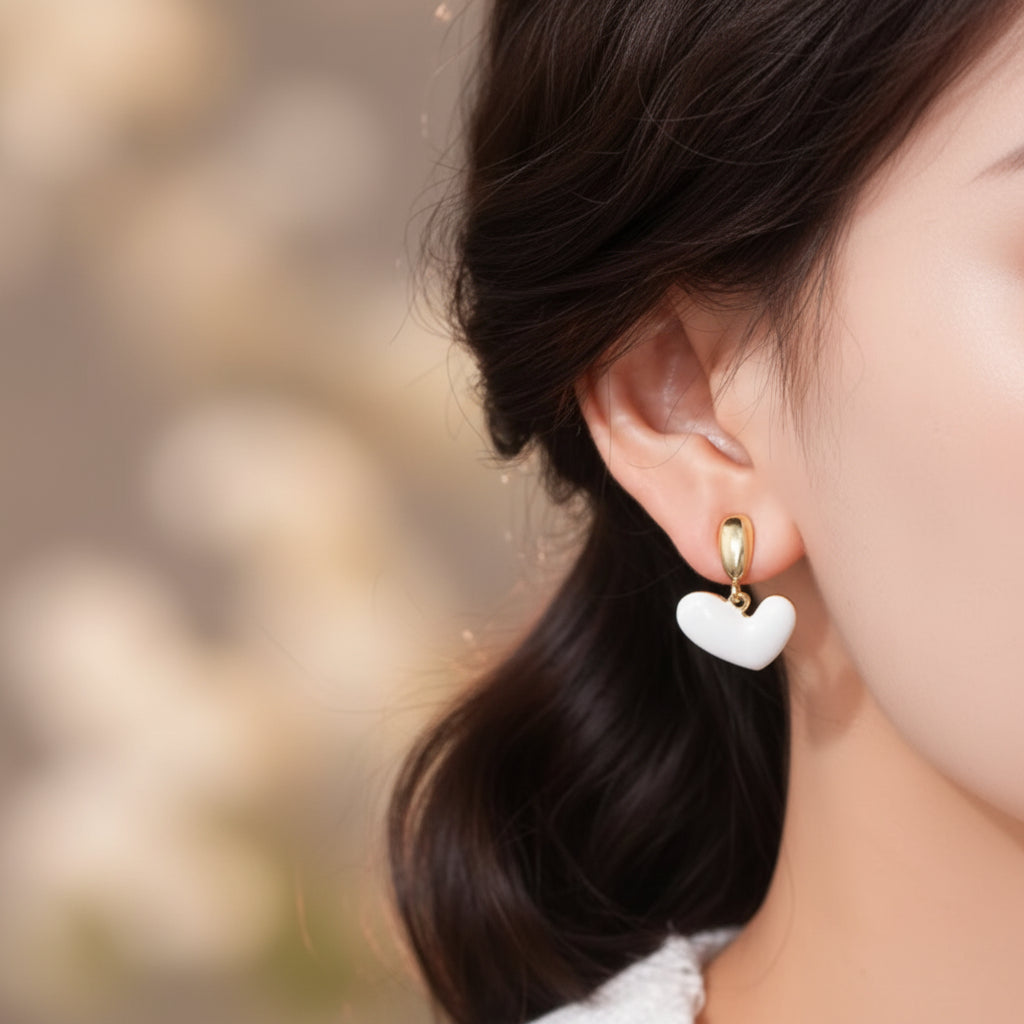 Close-up of a woman wearing a White Heart Drop Earrings