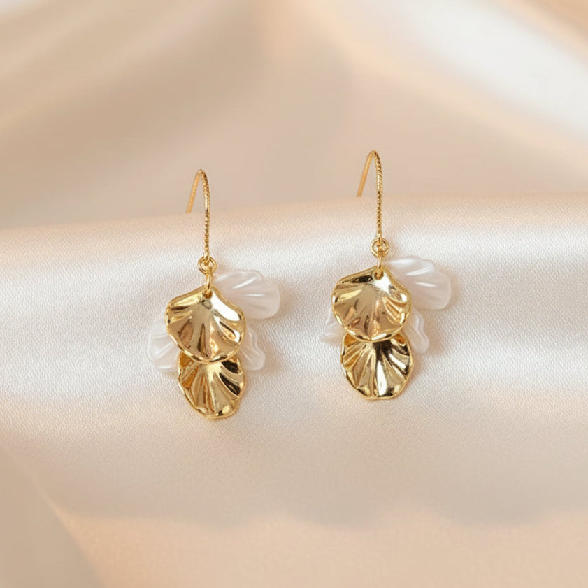 White and Gold Seashell Drop Earrings on beige