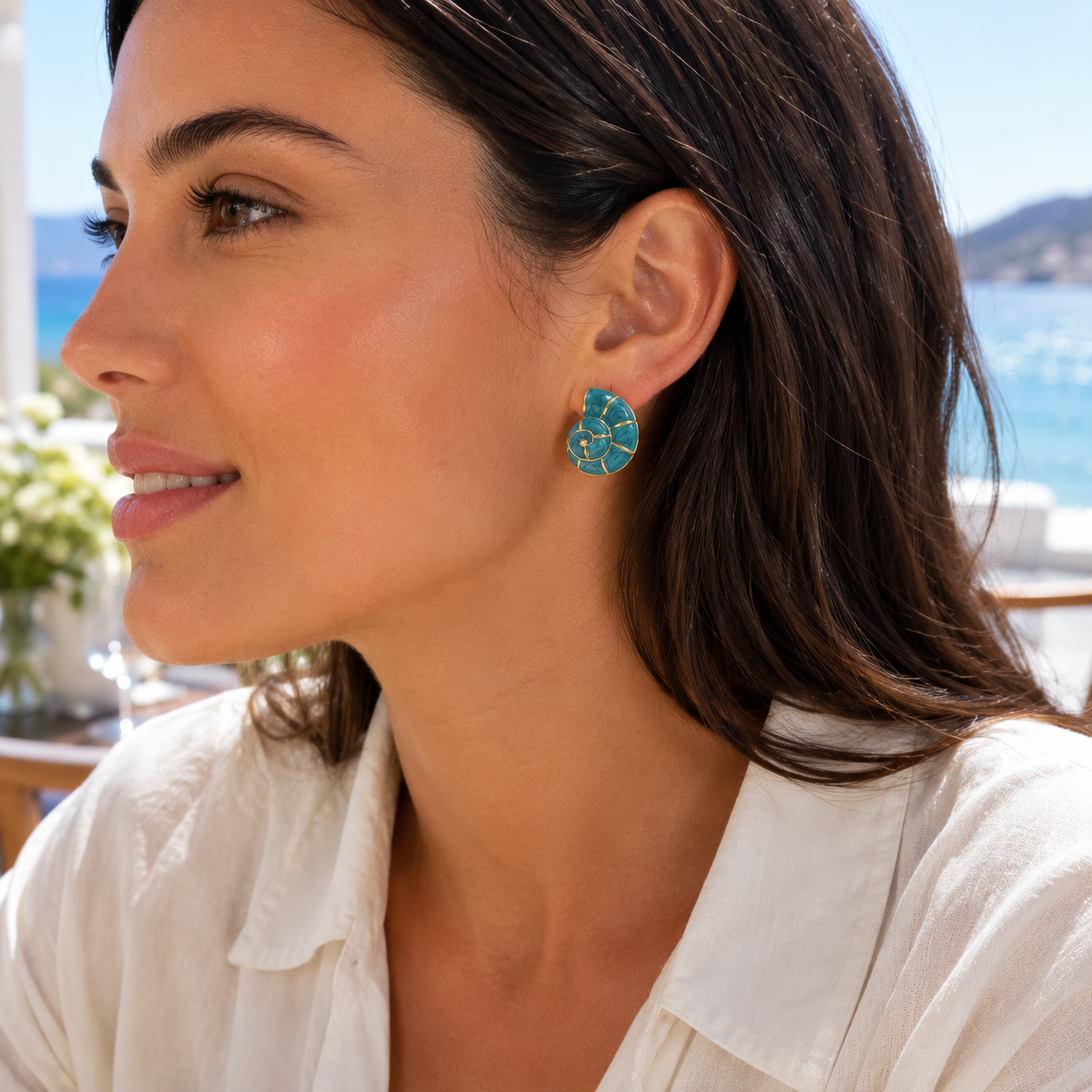 Woman wearing Turquoise Nautilus Shell Earrings at resort