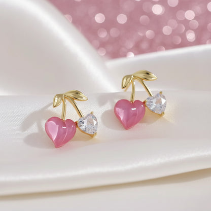 Pink Cherry & Crystal Heart Earrings with pink hearts and gold accents on a white plate.