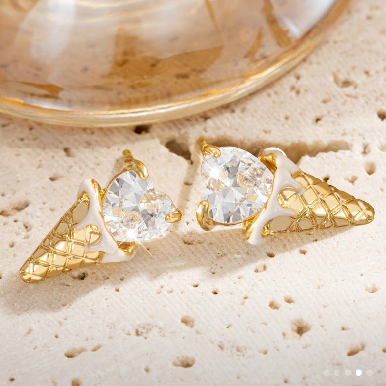 Crystal Heart Ice Cream Cone Earrings on a textured beige surface