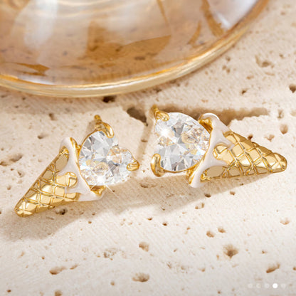 Crystal Heart Ice Cream Cone Earrings on a textured beige surface
